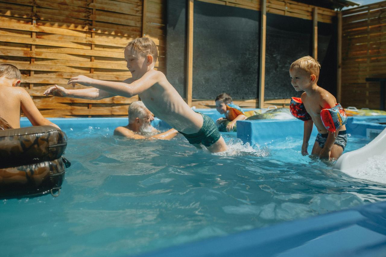 countryside village gites poolside families playing
