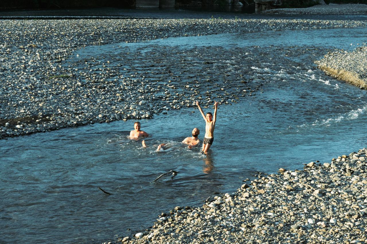 family playing in river water sunny day vacation