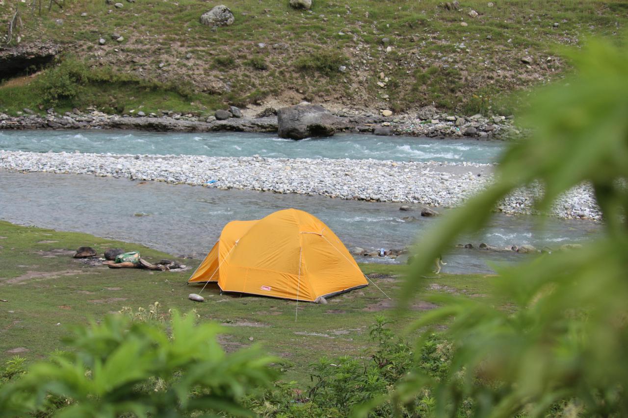 camping site river view tent setup morning