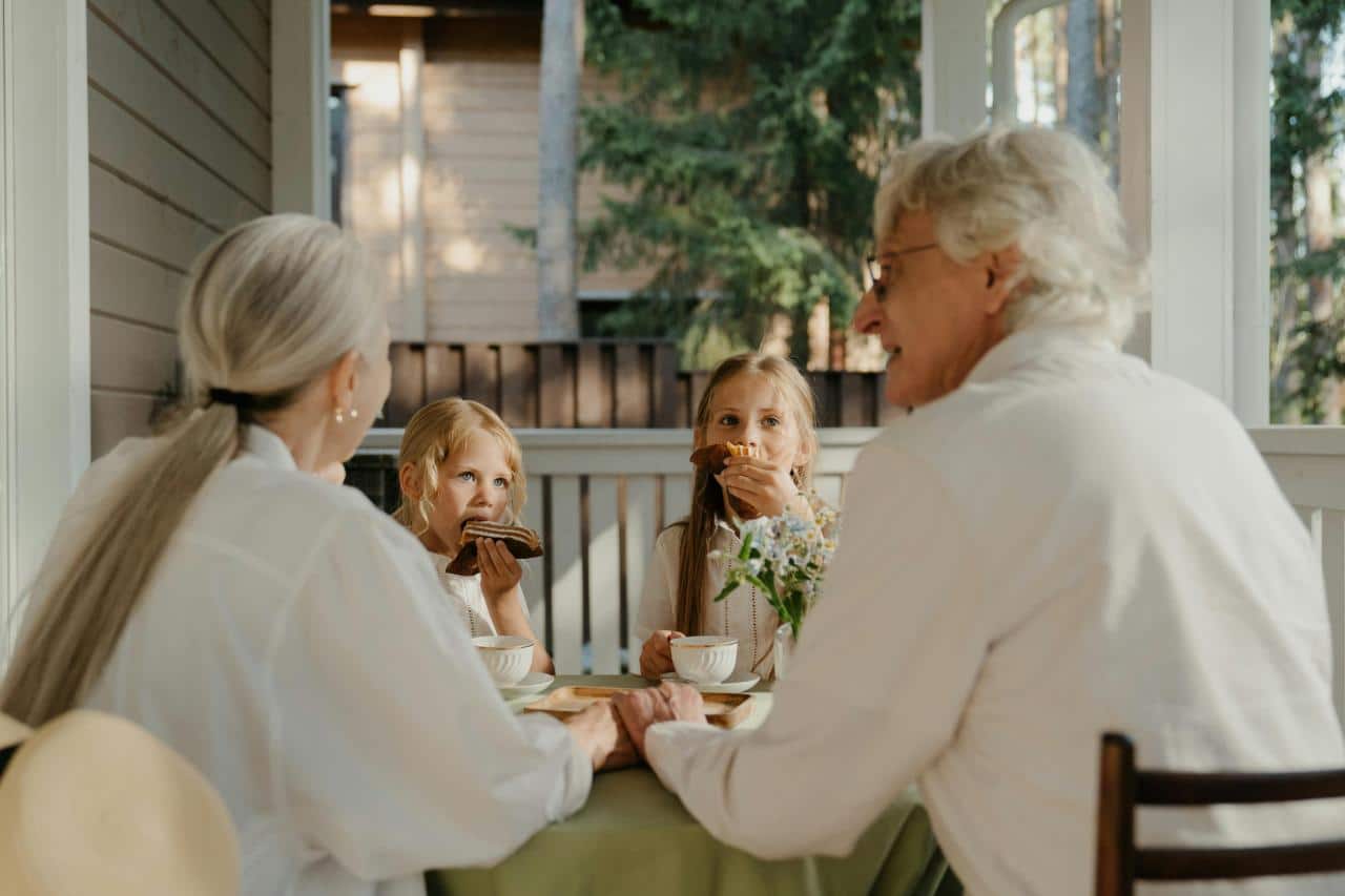 family group having breakfast outdoor patio