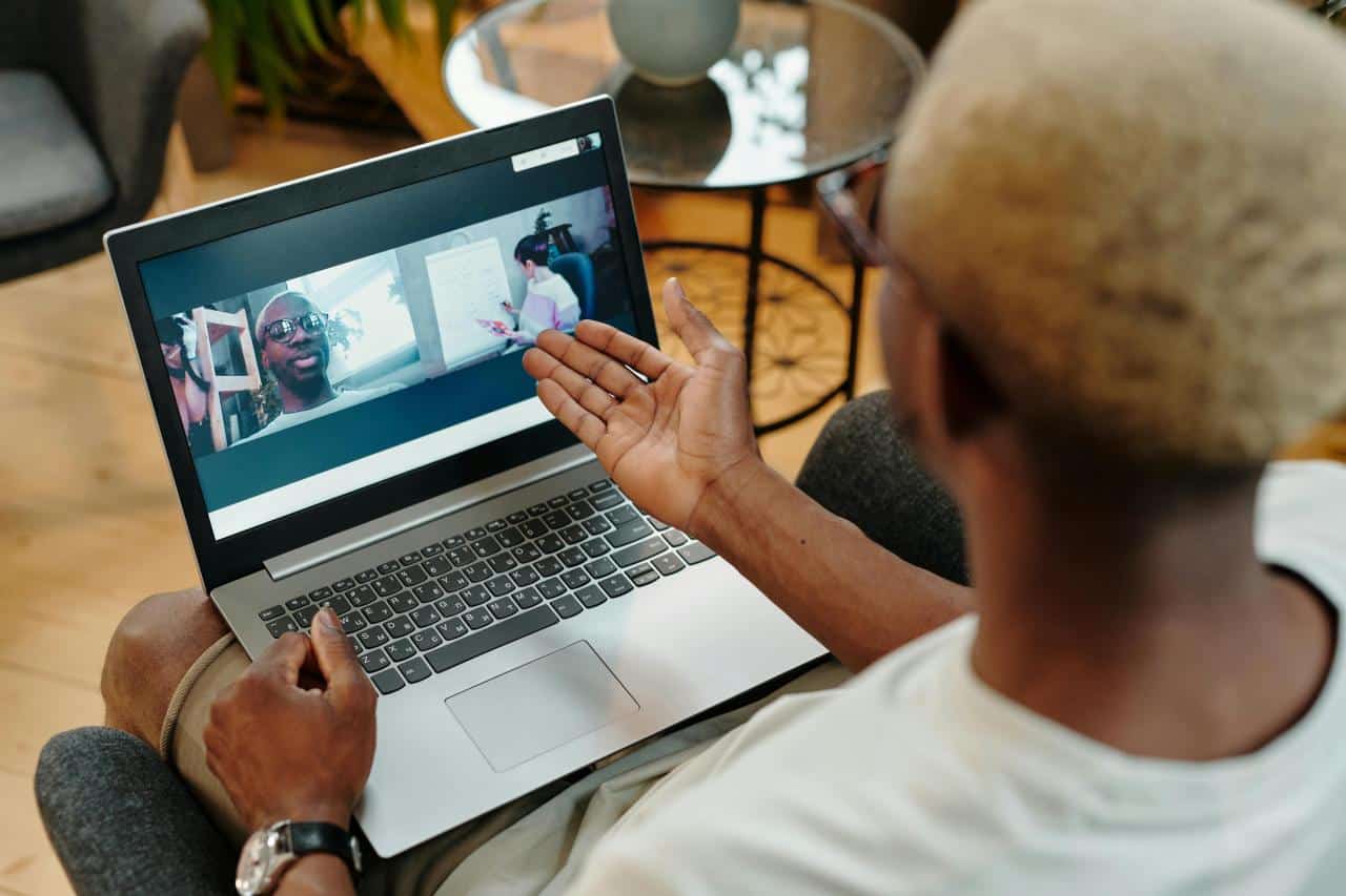 person using laptop video call conversation