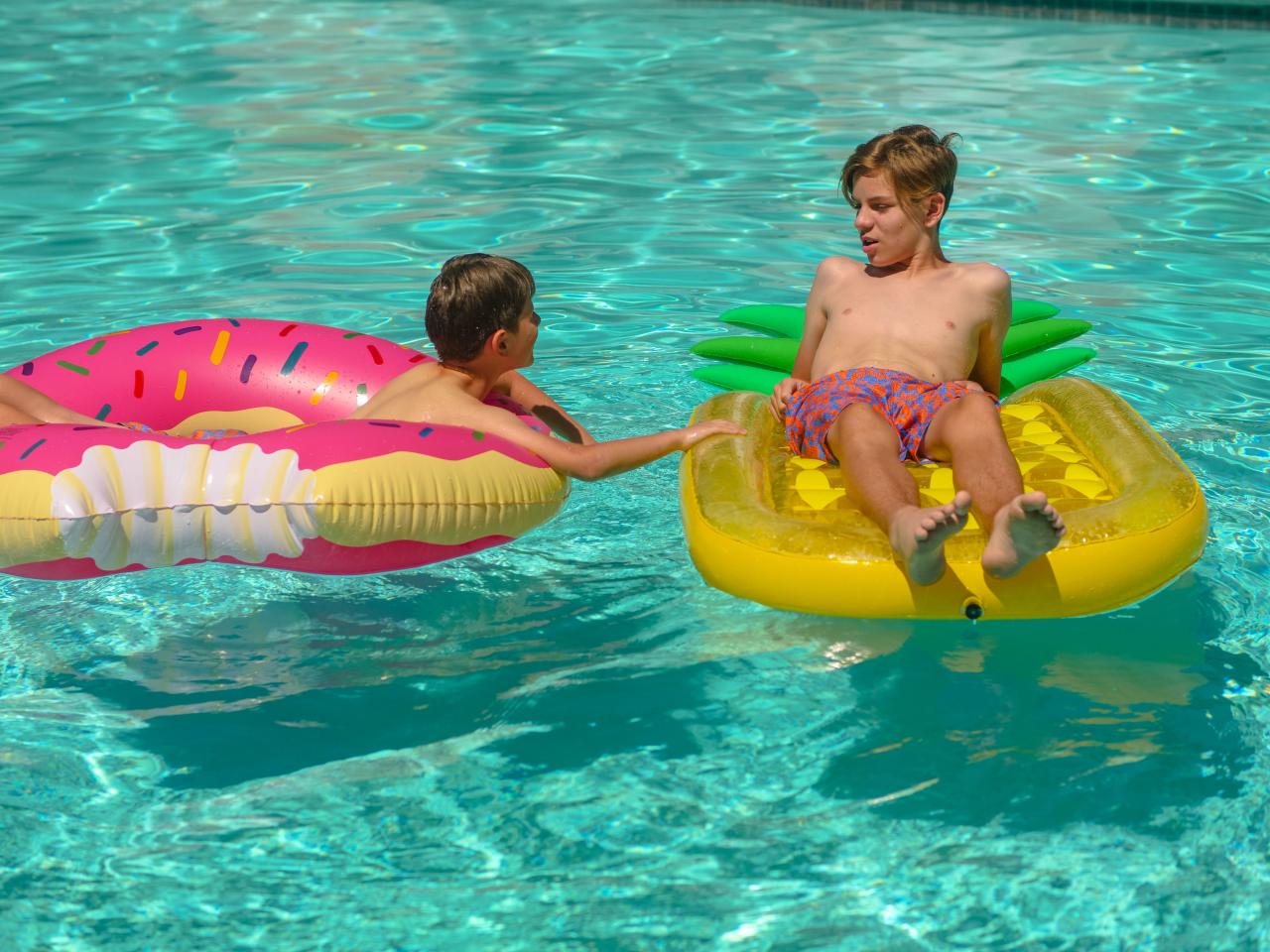 children playing in outdoor heated pool sunset